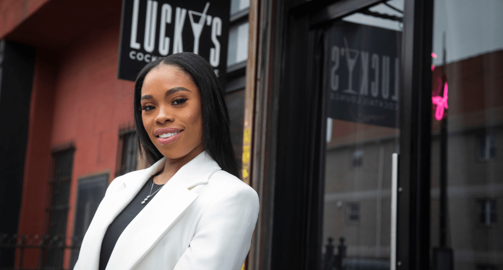 Nickquae Williams standing in front of her restaurant Lucky's Cocktail